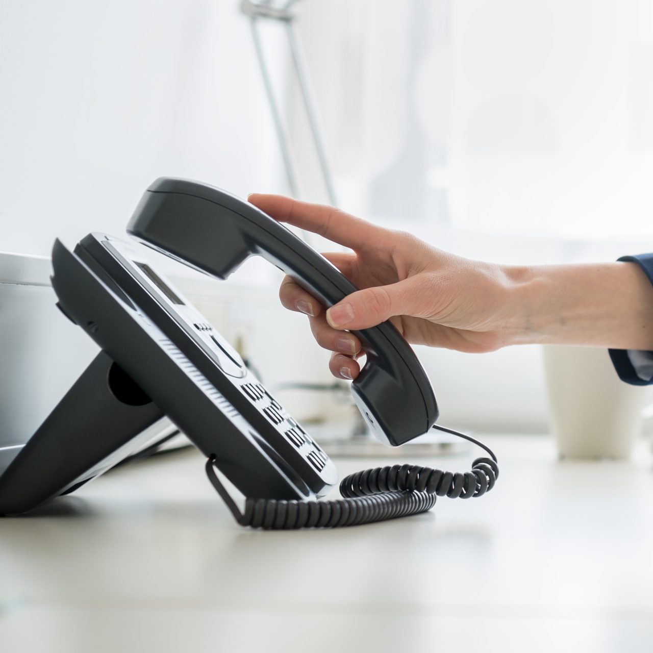 someone picking up a landline phone