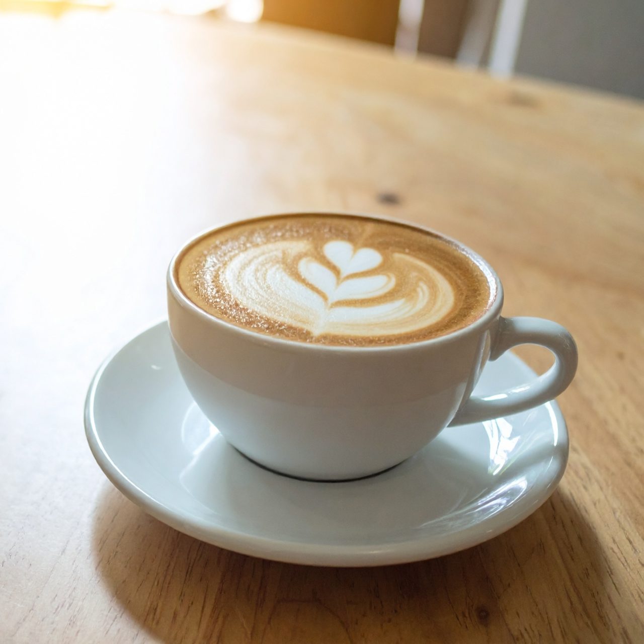 latte in a mug on a saucer on a table